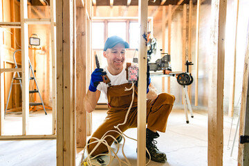 An Electrician Male Working on basement electricity part