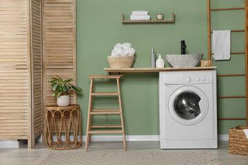 Stylish laundry room with functional washing machine. Interior design