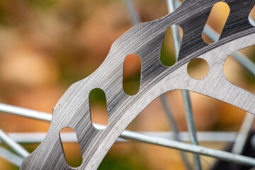 Bicycle disk brakes close up, grey metal disc attached to bike wheel, effective popular mountain...