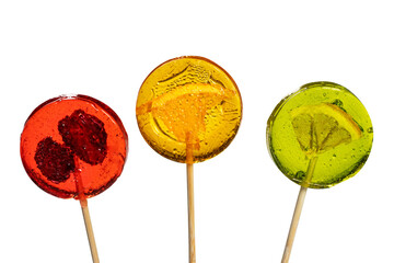 Sweet colorful lollipops with dried fruits on white background