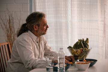 A lonely, anxious, physically and mentally uncomfortable elderly man with recent international...