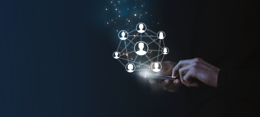 Businessman using mobile smartphone and icon network connection, business network with VR icon diagram on dark background.