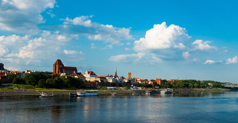  04-07-2022: View of Old City of Torun. Vistula (Wisla) river against the backdrop of the historical buildings of the medieval city of Torun. Poland. Europe