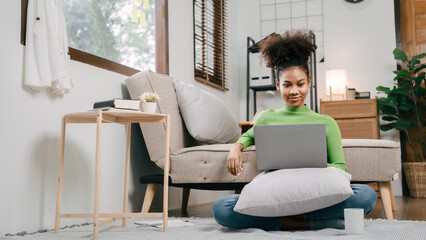 Using laptop pc, Pretty african american girl feeling fatigue lounge at sofa, happy calm lady dream enjoy wellbeing breathing fresh air in summer free time holiday.