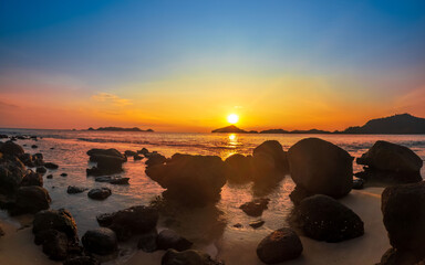Obraz na płótnie Canvas Beach and rocks in seaside. Beautiful dramatic ocean sunset