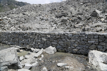 Rudarprayag, Uttarakhand, India, June 17 2014,Laborer building safety wall after Kedarnath...