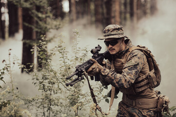A modern warfare soldier on war duty in dense and dangerous forest areas. Dangerous military rescue...