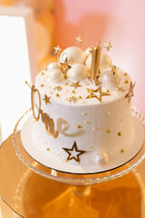 Birthday cake with a candle number 1 and the inscription one