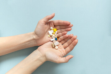 Hands of woman holding pills. Seasonal affective disorder concept