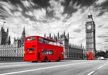 Fototapeta na wymiar Red bus on Westminster bridge next to Big Ben in London, the UK. Black and white
