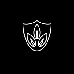 Shield with leaf icon isolated on black background. Eco-friendly security shield with leaf. 