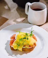 Egg benedict with hollandaise sauce and smoked salmon on toast
