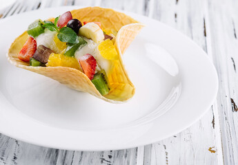 two scoops of natural organic fruit ice cream in a wafer cup