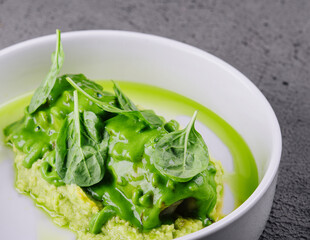 Squid with mashed avocado on stone