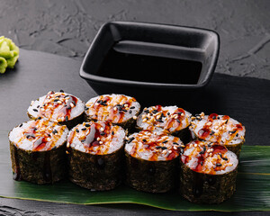 Traditional fresh japanese sushi futomaki on black stone