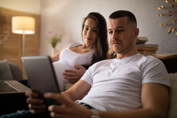 A pregnant woman and her husband buy things online.