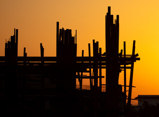 Silhouette building construction at sunset.