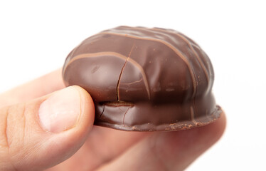 Chocolate candy in hand isolated on white background