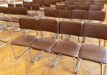 Brown chairs in the auditorium as background