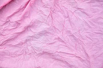 Fototapeta premium (Несколько значений)Pink crumpled fabric as a background.