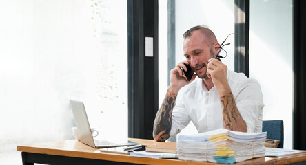 Happy business man with phone call while relaxing in the office