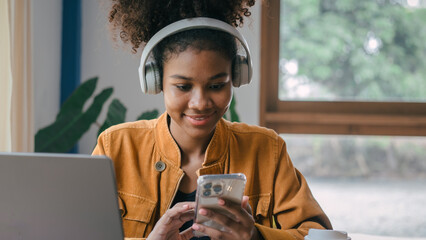 Using headphones. Young african american university foreign exchange students study online on...