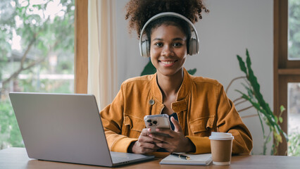 Using headphones. Young african american university foreign exchange students study online on...