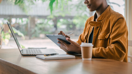 Using headphones. Young african american university foreign exchange students study online on laptop pc english language class by international specialists with master at cafe.