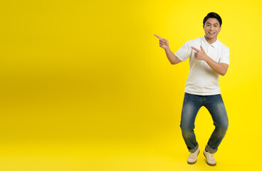 Fototapeta na wymiar Portrait of young asian man posing on yellow background