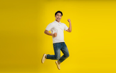 Fototapeta na wymiar Full length image of young Asian man on yellow background
