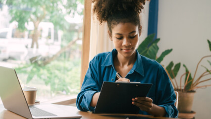 African american housewife looking at grocery household account family income and expenses.