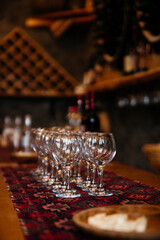 Wine tasting in Armenia. Many empty glasses stands on table with traditional rug patterns.
Cheese plate on background 