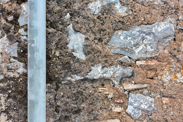 Weathered House Wall with Downward Pipe: Aged Texture Background