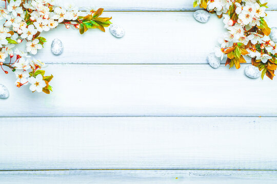 Easter white background. Spring flower border, white happy easter egg on wooden spring background. Easter card. Flat lay.