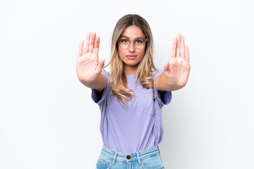 Young Uruguayan woman isolated on white background making stop gesture and disappointed