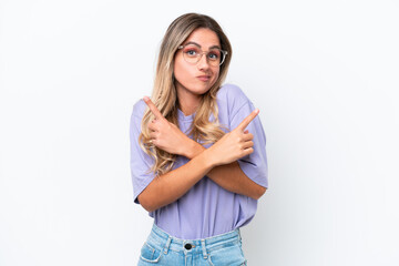 Young Uruguayan woman isolated on white background pointing to the laterals having doubts