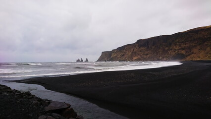 Reynisdrangar, Iceland - March 26, 2018: black sand beach on a stormy day with nobody