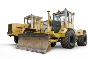 Two yellow heavy wheeled tractors isolated on transparent background