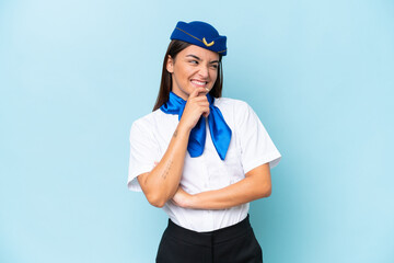 Airplane stewardess caucasian woman isolated on blue background looking to the side