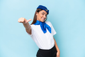 Airplane stewardess caucasian woman isolated on blue background giving a thumbs up gesture