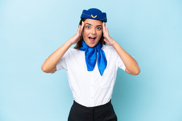 Airplane stewardess caucasian woman isolated on blue background with surprise expression