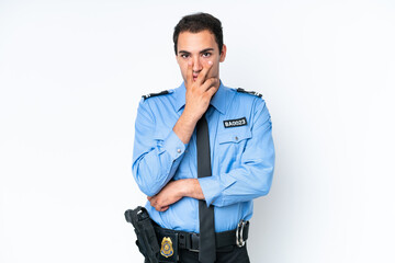 Young police caucasian man isolated on white background surprised and shocked while looking right