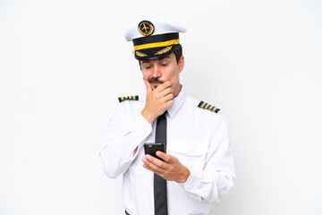 Airplane caucasian pilot isolated on white background thinking and sending a message