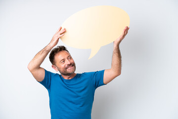 Middle age caucasian man isolated on white background holding an empty speech bubble and with sad expression