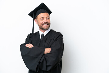 Middle age university graduate man isolated on white background with arms crossed and happy