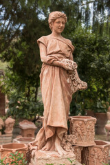 Terracotta statue of woman holding roses, for sale in Impruneta, Italy