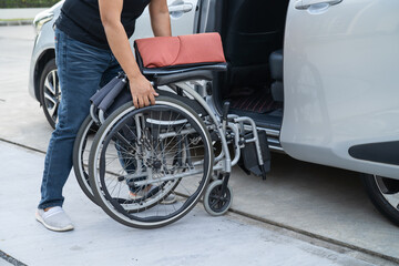 Fototapeta premium Asian disability woman on wheelchair getting in her car, Accessibility concept.
