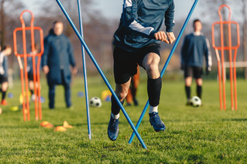 Football player training in soccer field. Young soccer player practicing strength and agility skills on training session. Football running through a training obstacle course.