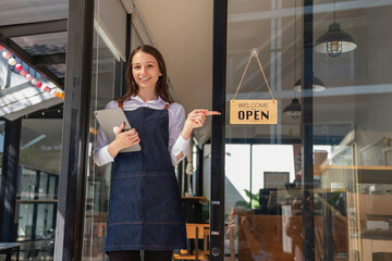 Portrait of a woman, a coffee shop business owner smiling beautifully and opening a coffee shop that is her own business, Small business concept..