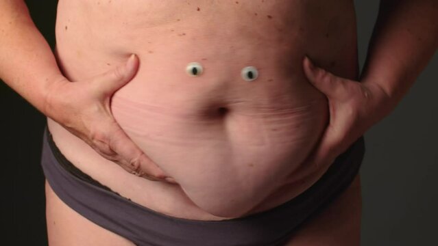 Close up of fat woman. Woman folds of skin and fat on stomach. Weight loss or weight gain. Bad food and unhealthy food